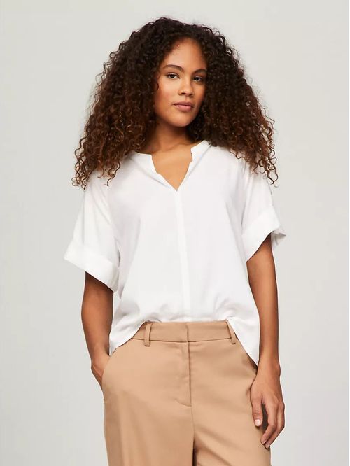 Blusa con un botón dorado en la manga